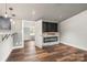 Open layout of living room featuring a modern fireplace and wood flooring at 5354 Sherrills Ford Rd, Catawba, NC 28609
