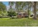 Beautiful home featuring a spacious backyard with a deck, screened porch, and well-maintained landscaping at 5707 Fairvista Dr, Charlotte, NC 28269