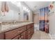 Bathroom with double vanity, granite countertops, and a shower/tub combo at 5707 Fairvista Dr, Charlotte, NC 28269