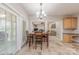 Bright breakfast nook features a dining table, chandelier and access to the living room and kitchen at 5707 Fairvista Dr, Charlotte, NC 28269