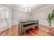 Formal dining room with hardwood floors, decorative molding, elegant chandelier, and natural light at 5707 Fairvista Dr, Charlotte, NC 28269