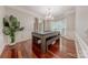 Formal dining room with hardwood floors, decorative molding, elegant chandelier, and natural light at 5707 Fairvista Dr, Charlotte, NC 28269
