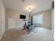A dedicated exercise room featuring workout equipment and a mounted television at 5707 Fairvista Dr, Charlotte, NC 28269
