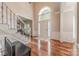 Grand foyer featuring hardwood floors, staircase with wrought iron spindles, and ample natural light at 5707 Fairvista Dr, Charlotte, NC 28269