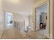 Upstairs hallway boasts neutral carpet, open stairway and access to the other rooms at 5707 Fairvista Dr, Charlotte, NC 28269