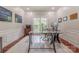Bright home office featuring hardwood floors, natural light, and a modern glass desk at 5707 Fairvista Dr, Charlotte, NC 28269