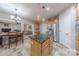 Spacious kitchen featuring an island with seating, stainless steel appliances, and a view into the cozy living room at 5707 Fairvista Dr, Charlotte, NC 28269