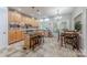 Bright and modern kitchen with stainless steel appliances, island with seating, and an adjacent dining area at 5707 Fairvista Dr, Charlotte, NC 28269