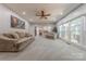 Bright living room boasts neutral colors, large windows, and ample seating, creating a welcoming atmosphere at 5707 Fairvista Dr, Charlotte, NC 28269