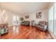 Spacious living room with hardwood floors, modern lighting, and ample seating at 5707 Fairvista Dr, Charlotte, NC 28269