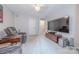 Entertainment room featuring comfortable seating, a large television, and neutral color scheme at 5707 Fairvista Dr, Charlotte, NC 28269