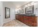 Luxurious main bathroom features a double vanity, tile flooring and multiple mirrors at 5707 Fairvista Dr, Charlotte, NC 28269