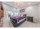 Spacious main bedroom features a tray ceiling, ceiling fan and access to the bathroom at 5707 Fairvista Dr, Charlotte, NC 28269