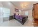 Spacious main bedroom features a tray ceiling, ceiling fan and two large windows at 5707 Fairvista Dr, Charlotte, NC 28269