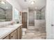 A bathroom with a double vanity sink, a large mirror, and tiled walk-in shower at 5720 Enochville School Rd, Kannapolis, NC 28081