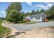 Charming home with wood decks and a gravel driveway, nestled in a serene, wooded landscape at 5720 Enochville School Rd, Kannapolis, NC 28081