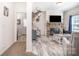 Bright living room featuring a stone fireplace and neutral tones, with wood-look floors for a rustic feel at 5720 Enochville School Rd, Kannapolis, NC 28081