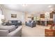 Living room flowing into a kitchen area with light gray couches and carpeted floors at 5720 Enochville School Rd, Kannapolis, NC 28081