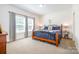 A main bedroom featuring two windows, a wrought iron bed frame and matching side tables at 5720 Enochville School Rd, Kannapolis, NC 28081