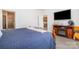 A main bedroom with access to an ensuite bathroom, wood floors, and a wooden media center at 5720 Enochville School Rd, Kannapolis, NC 28081
