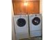 Laundry room includes a washer and dryer beneath upper cabinets at 5727 Dockside Dr, Charlotte, NC 28227