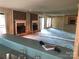 Spacious living room with brick fireplace, large mirror, and access to a patio area at 5727 Dockside Dr, Charlotte, NC 28227