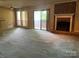 Large living room with fireplace, sliding glass doors, and neutral-toned wallpaper at 5727 Dockside Dr, Charlotte, NC 28227