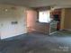 Living room with view into the kitchen, light brown textured wallpaper, and sliding glass doors to patio at 5727 Dockside Dr, Charlotte, NC 28227