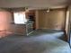 View of an open floor plan featuring kitchen, living room, ceiling fan, and outdoor access at 5727 Dockside Dr, Charlotte, NC 28227