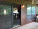Enclosed patio showing sliding door access to the kitchen, with view of cabinetry and appliances at 5727 Dockside Dr, Charlotte, NC 28227