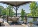 Covered back porch offering outdoor dining and lounge seating with stunning water views at 5888 Wood Duck Way, Catawba, NC 28609