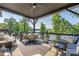 Inviting covered back porch with comfortable seating, dining set, and scenic views of the lake at 5888 Wood Duck Way, Catawba, NC 28609