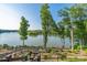 Serene backyard with landscaped steps leading to the lake and showcasing scenic views at 5888 Wood Duck Way, Catawba, NC 28609