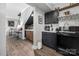 A modern bar area with black cabinets, marble countertops and coffee machine at 5888 Wood Duck Way, Catawba, NC 28609