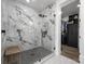 Modern bathroom features a glass shower with marble tile and a wood bench at 5888 Wood Duck Way, Catawba, NC 28609