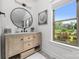 Light-filled bathroom vanity with marble countertop and a beautiful window view at 5888 Wood Duck Way, Catawba, NC 28609