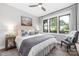 Bright bedroom featuring a ceiling fan, hardwood floors, and scenic views from the large windows at 5888 Wood Duck Way, Catawba, NC 28609