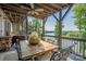 Spacious deck with a dining table set and scenic views of the lush green landscape and lake at 5888 Wood Duck Way, Catawba, NC 28609