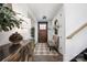 Bright foyer with hardwood floors, stylish decor, a wooden staircase, and a wooden front door at 5888 Wood Duck Way, Catawba, NC 28609