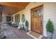 Inviting front porch features a wood ceiling and flooring, comfortable seating and decorations at 5888 Wood Duck Way, Catawba, NC 28609