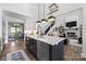 Gourmet kitchen with dark island, stainless steel appliances, pendant lighting, and open floorplan at 5888 Wood Duck Way, Catawba, NC 28609