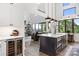 Gourmet kitchen features dark island, modern pendant lights, wood grain floors, and bar stool seating at 5888 Wood Duck Way, Catawba, NC 28609