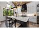 Spacious kitchen features dark island, pendant lights, marble countertops, and stainless steel appliances at 5888 Wood Duck Way, Catawba, NC 28609