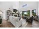 Bright, open living room featuring a fireplace, high ceilings, large windows and comfortable seating at 5888 Wood Duck Way, Catawba, NC 28609