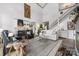 Bright open-concept living room featuring a fireplace and staircase to upper level, with views to gourmet kitchen at 5888 Wood Duck Way, Catawba, NC 28609
