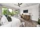 Main bedroom with tray ceiling, ceiling fan, large windows with view, and hardwood floors at 5888 Wood Duck Way, Catawba, NC 28609