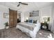 Bright main bedroom boasts ceiling fan, hardwood floors, large windows, and barn door to bathroom at 5888 Wood Duck Way, Catawba, NC 28609