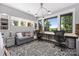 Spacious home office with multiple desks, a comfortable sofa, and large windows showcasing beautiful views at 5888 Wood Duck Way, Catawba, NC 28609