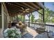 Inviting covered patio with water view, dining set and hanging chair. Perfect spot for outdoor relaxation at 5888 Wood Duck Way, Catawba, NC 28609