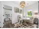 Cozy sitting area with a decorative rug, white sofa, accent chairs, and stylish lighting at 5888 Wood Duck Way, Catawba, NC 28609